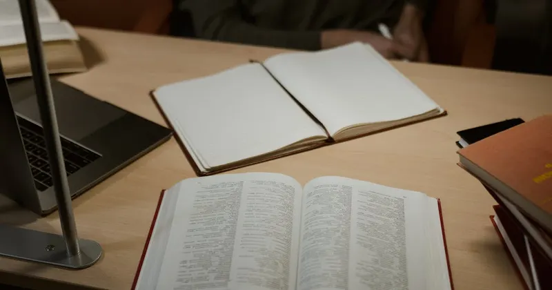Organized school supplies with notebook and books on a wooden desk