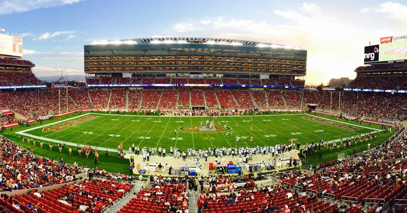 NFL stadium packed with fans cheering during fall football gameday