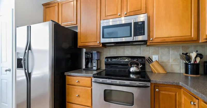 A kitchen with stainless steel appliances and wooden cabinets