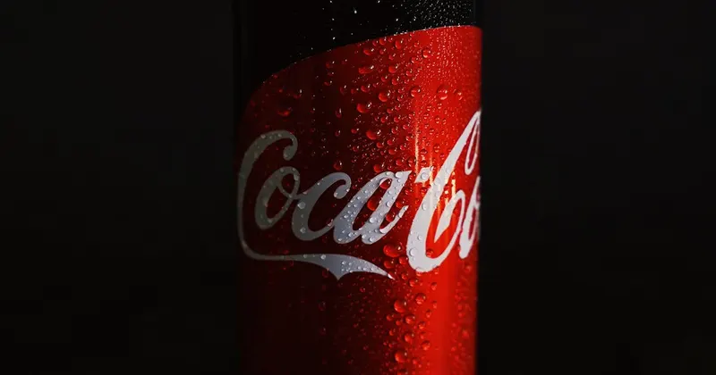 Coca-Cola can on a dark black surface