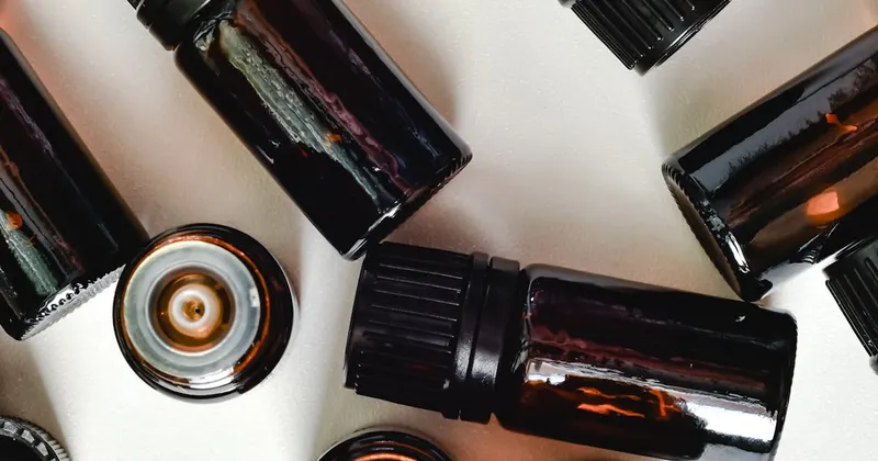 Essential oil bottles arranged on a white surface