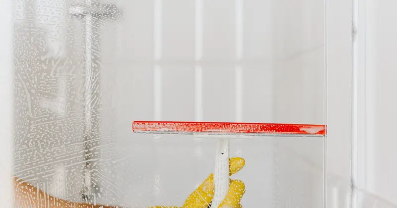 Professional cleaner wiping kitchen counter