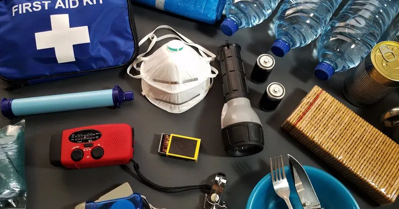First aid and survival kit supplies laid out for emergency preparedness