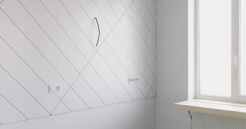 Empty room with white walls and wooden floor in a new home