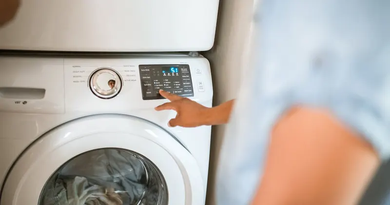 Person using a front-load washing machine