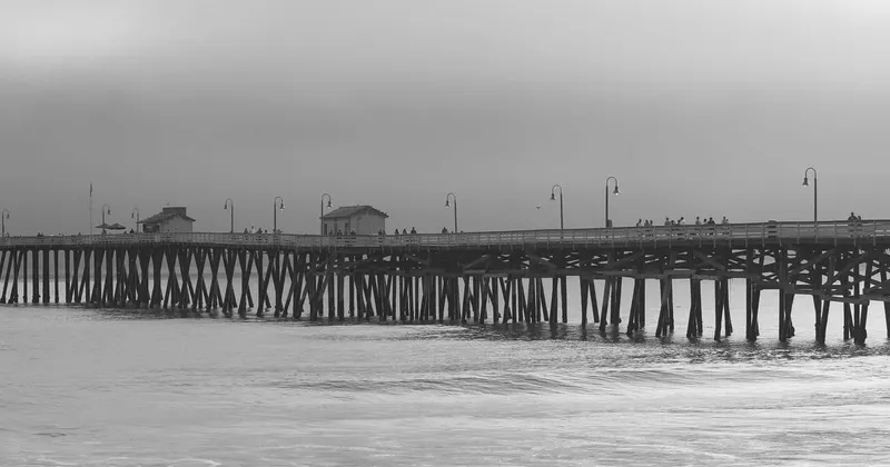 Person wearing rubber gloves holding spray bottle for home cleaning